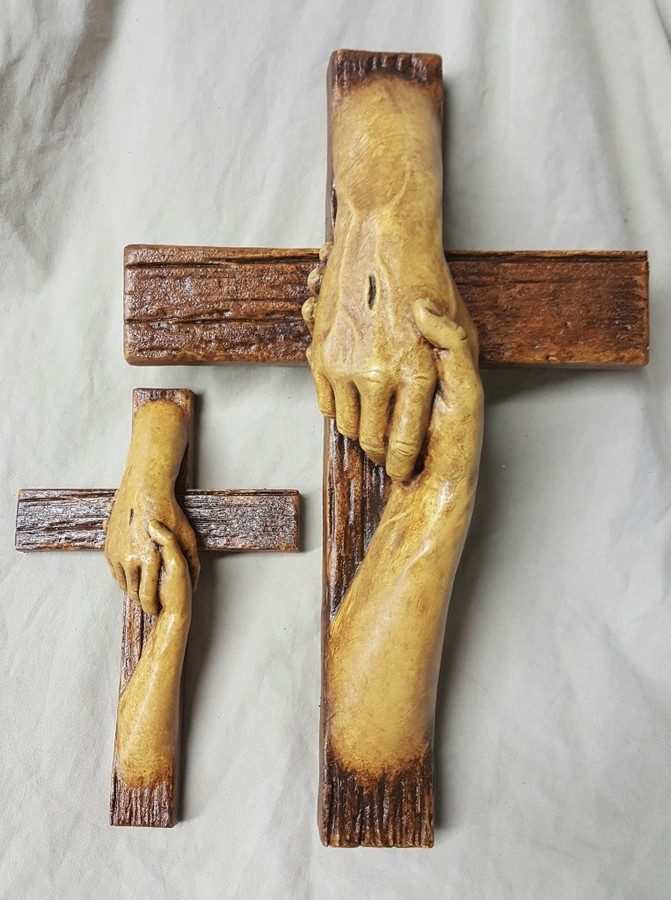 Tom White Studios, Inc | Cross Sculptures Rescued Cross bronze sculpture created by Christian sculptor, Tom White. Depicts Jesus nail-scarred hand rescuing mankind by His great love shown on Calvary by His death and the power of His Resurrection. Available in necklaces and wall hangings