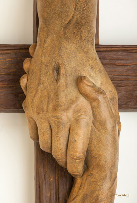 Tom White Studios, Inc | Cross Sculptures Rescued Cross bronze sculpture created by Christian sculptor, Tom White. Depicts Jesus nail-scarred hand rescuing mankind by His great love shown on Calvary by His death and the power of His Resurrection. Available in necklaces and wall hangings