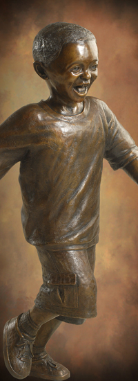 Bronze sculpture of laughing running boy