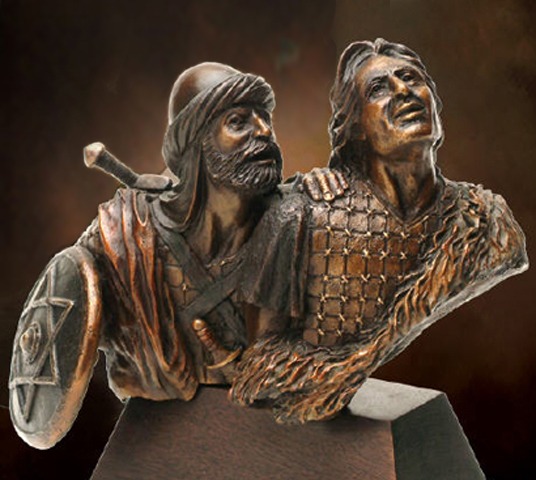 Two medieval warriors in detailed bronze sculpture.