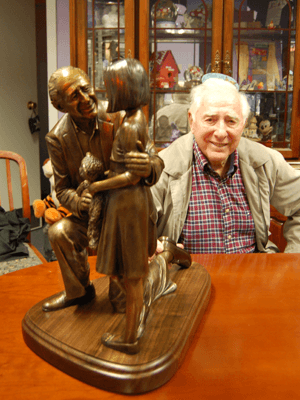 Henri Landwirth & Little Girl portrait bronze sculpture. Tabletop statue version of the monumental sculpture scene commissioned by Give Kids the World Village foundation to honor Henri, their founder, for his lifetime of service to children and their families struggling with life-threatening illness. Sculptor, Tom White.