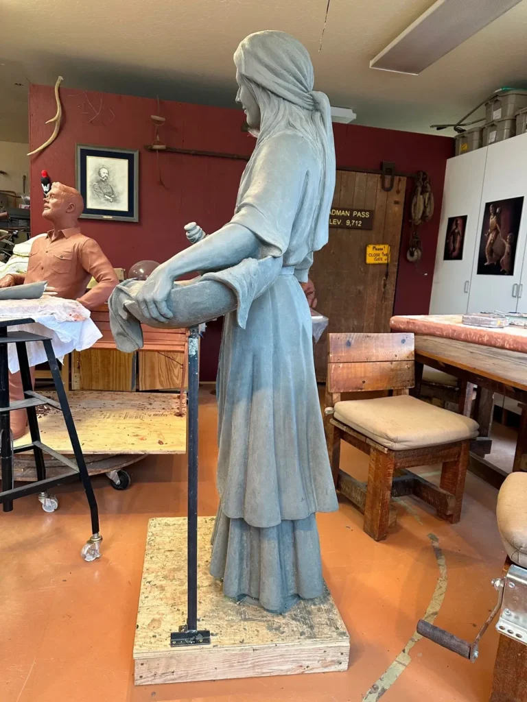 Tom White Studios, Inc | St Angela Merici & Dorothy Kazel Saint Angela Merici Statue & Dorothy Kazel bronze portrait sculpture scene commissioned by Urban Community School and created by Tom White, Sculptor. St Angela Merici was the founder of the Ursuline nuns in the 1400’s