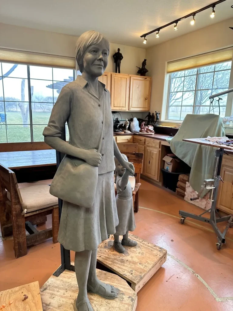 Tom White Studios, Inc | St Angela Merici & Dorothy Kazel Saint Angela Merici Statue & Dorothy Kazel bronze portrait sculpture scene commissioned by Urban Community School and created by Tom White, Sculptor. St Angela Merici was the founder of the Ursuline nuns in the 1400’s