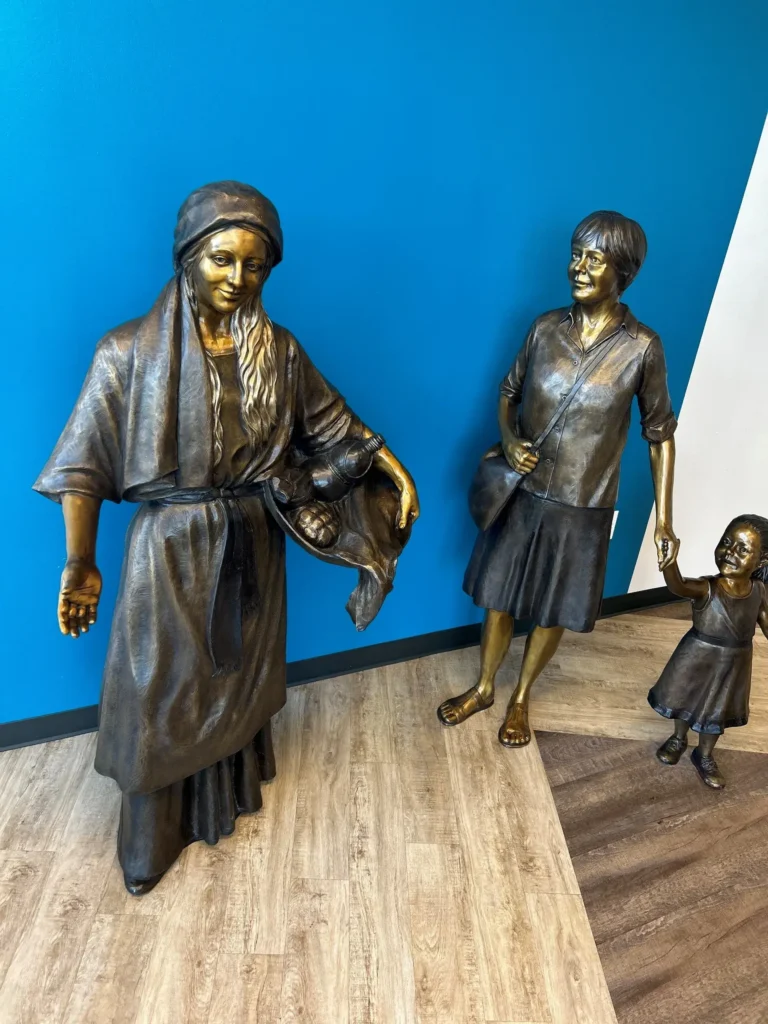 Tom White Studios, Inc | St Angela Merici & Dorothy Kazel TSaint Angela Merici Statue & Dorothy Kazel bronze portrait sculpture scene commissioned by Urban Community School and created by Tom White, Sculptor. St Angela Merici was the founder of the Ursuline nuns in the 1400’s